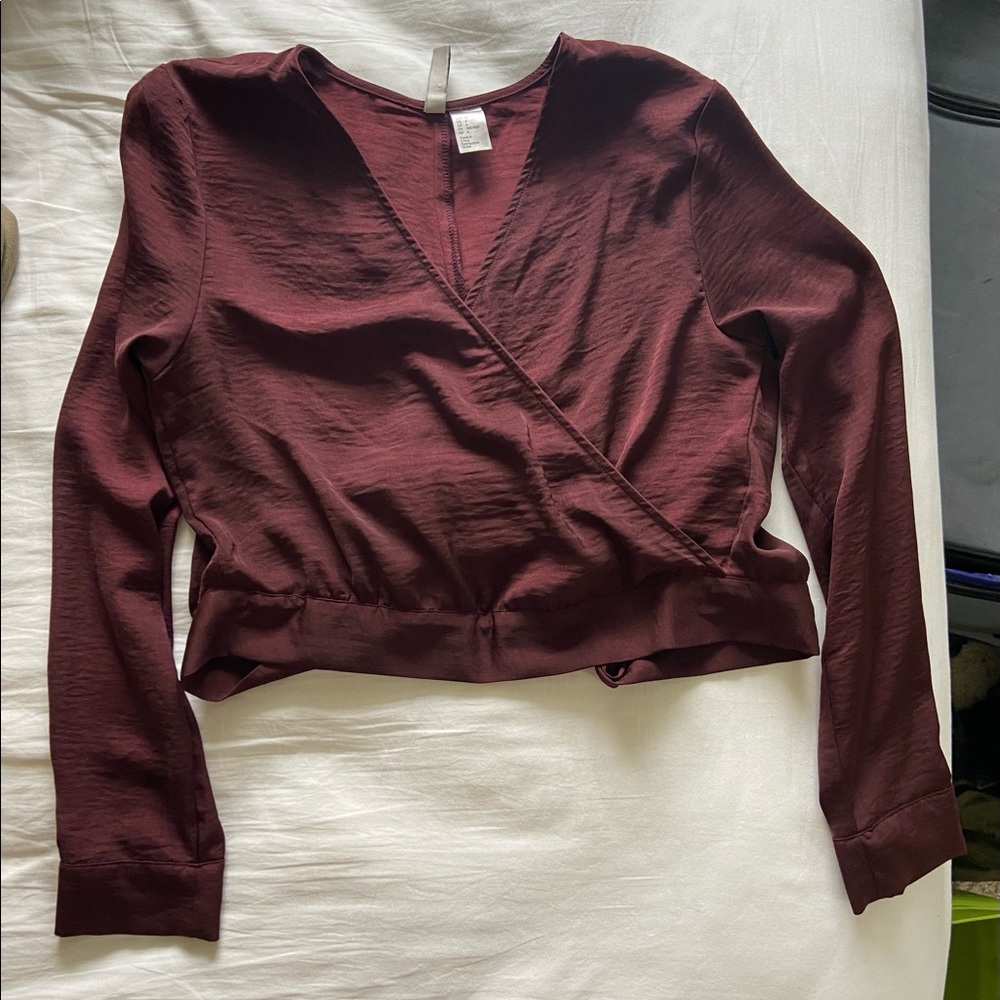 Maroon deep V, slightly cropped top with a tie in the back.